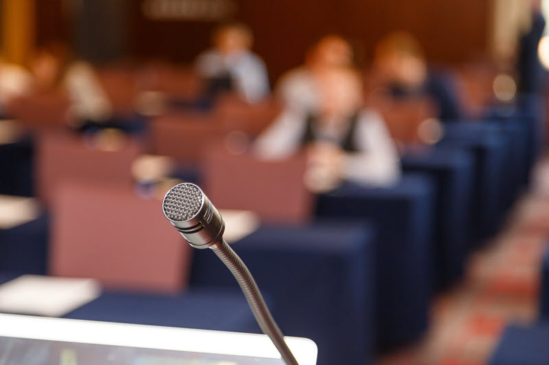 microphone-over-conference-hall-background-2021-08-26-17-11-18-utc.jpg